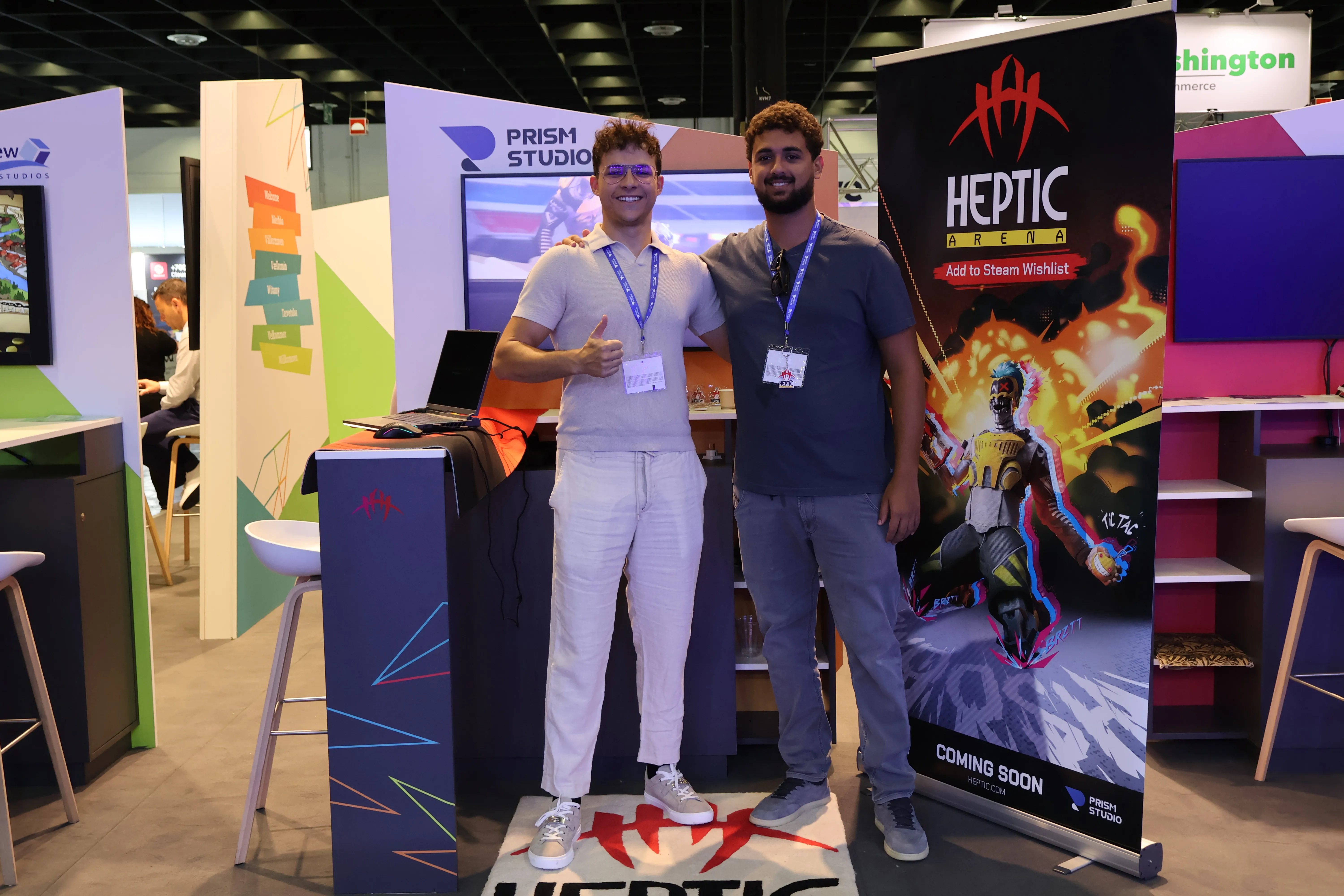 Heptic Arean Announcement trailer - Matteo And youssif standing at the booth at gamescom